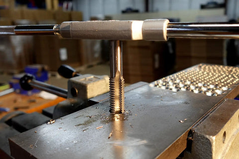 5/8-11 National Fine Plug Tap For Metalworking Projects In High Carbon Steel in use on a workbench, Century Drill Model 95115