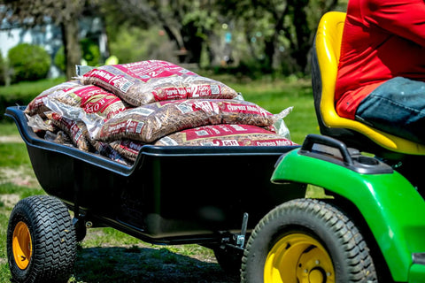 Heavy-Duty ATV UTV Utility Trailer With 1500 Lb Capacity, 22 Cu Ft Poly Tub carrying bags, attached to lawn tractor