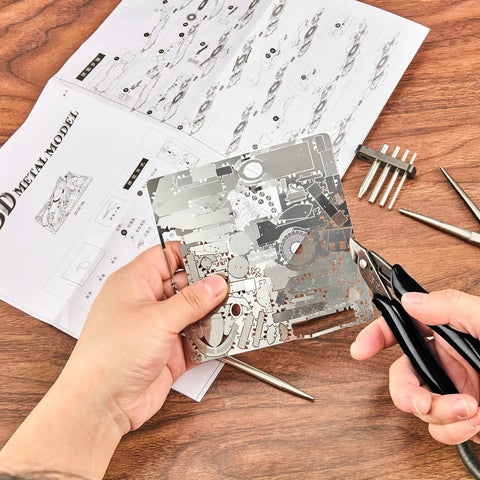 Person assembling 3D metal jigsaw puzzles with Ten Piece Metal DIY Model Tool Set For 3D Metal Jigsaw Puzzles Assembly With Edge.