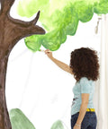 Person painting tree on Paintable Removable Peel And Stick Wallpaper For Walls Create Your Own Designs Easy No Mess Self Adhering