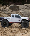 SCX24 Base Camp 4x4 Rock Crawler Ready To Run RC Truck in white, 1/24 scale, on rocky terrain