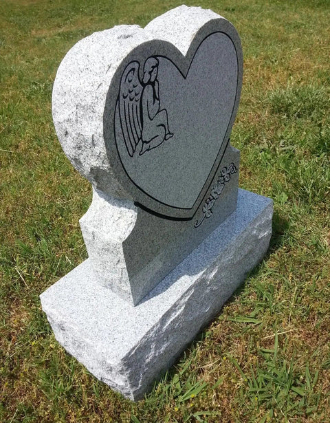 Heart Cemetery Memorial Headstone And Base With Two Design Options, Custom Engraved Gray Granite Upright Monument, Polished Die With Matching Base For Grave; side view of heart-shaped stone in grass