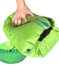 Heavy Duty Travel Laundry Sack Featuring Slick Inner Washboard Grooves, green waterproof bag being held, compact for camping and travel.