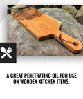 Wooden cutting board on rock surface, enhanced with Hemp Wood Oil Finish For Cutting Boards, Butcher Blocks, Countertops And Wooden Utensils, Food Grade, Matte Non Glossy Coat, Revives Old Wood, Food Safe Oil Treatment, Quick To Apply, 1 Gallon.