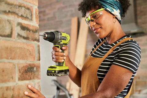Top Notch 18 Volt Power Tool Combo Kit Featuring A Killer Impact Drill Driver and Smooth Cordless Jigsaw with a user drilling into brick.