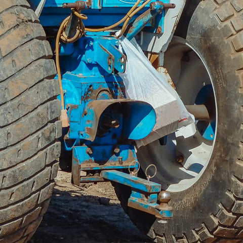 Close-up of tractor hitch with Heavy Duty Galvanized Steel Retaining Pin Set With Circular Ring O Ring Lock Pins in use.