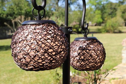 Close-up of dual suspended woven rattan shades on Castillo Outdoor Floor Lamp With Oil Rubbed Bronze Highlight Finish
