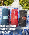 Grip Compact Bluetooth Speaker With Bold Pro Sound, pink, red, and blue speakers in water showing Auracast connection