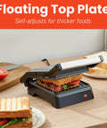 Compact Panini Press And Contact Grill With Floating Top Plate To Make Juicy Sandwiches Quickly, black finish, grilling sandwich with vegetables.