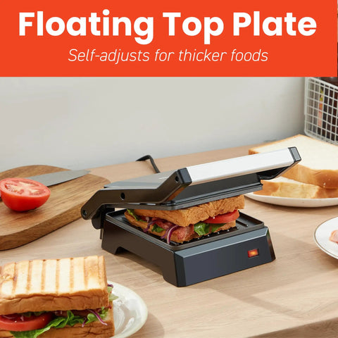 Compact Panini Press And Contact Grill With Floating Top Plate To Make Juicy Sandwiches Quickly, black finish, grilling sandwich with vegetables.