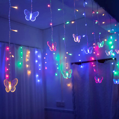 Butterfly Curtain Lights 13ft 96 LED Fairy String With Remote 8 Modes Multicolor Vibe hanging in a colorful room setup