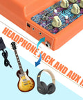 Rechargeable Tiny 20W Guitar Amp For Desktop Practice With Distortion Delay Aux In And Headphone Jack Stereo 2x10W 4 Ohm Speakers Portable CA100G displayed with guitar, headphones, and power adapter