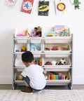 Child playing with a 12 Bin Toy Storage Organizer For Kids Playroom, 4-Tier Toy Organizer In Grey And White, toys neatly arranged