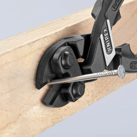 High Leverage CoBolt Cutter With Notch And Spring For No Sweat, Effortless Cuts cutting a nail in wood, comfort grip handles visible