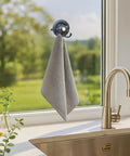 Heavy Duty Suction Cup Hook With Bombproof Grip For Window And Glass Walls Featuring Industrial Grade Nano Pu Base hanging a towel.