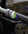LeakFinder LF021 automotive leak-detection dye at hose fitting; green oil-based dye with purple marks