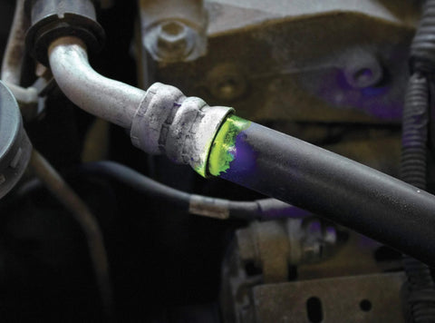 LeakFinder LF021 automotive leak-detection dye at hose fitting; green oil-based dye with purple marks