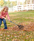 Child using Heavy Duty Garden Rake With Adjustable Long Handle And Stainless Steel Pole Six Feet Tall 25 Tines For Leaves Yard Work Clean Up Windows And Lawn Durable 1.1 Inch Diameter Shaft And Comfy Rubber Grip on lawn