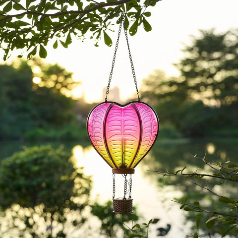 Heart Shaped Solar Lantern For Outdoor Decor Bright Hanging Light With Flickering Flame Garden Party Accent That Starts The Night Right Ideal For Valentines Day Anniversary Wedding Mothers Day And Backyard Lit Vibe, hanging in a garden during sunset.