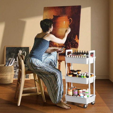 Artist using Three Tier Rolling Cart Organizer With Lockable Wheels And Reinforced Handle for paint storage in studio