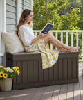 Woman sitting on 78 Gallon Outdoor Deck Box Large Resin Storage Box For Patio Cushions Garden Tools And Yard Gear With Lockable Lid