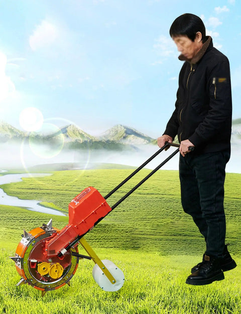 Person using Walk Behind Manual Seeder With Sixteen Precise Nozzles For Row Crops And Gardens, Durable Steel Frame, in field