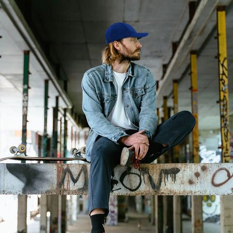 Man wearing a Vintage Style Women's Breathable Cap With Adjustable Buckle Strap Dope Front Artwork Hat In Classic Blue