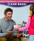 Child giving a packaged gift using 200 Pack Heat Shrink Wrap Bags In Three Sizes 3.93 X 5.90 Inches 7.67 X 9.64 Inches And 9.64 X 11.61 Inches Clear PVC Film.