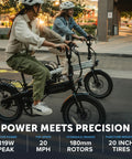 Two adults riding XP Lite2 Folding Electric Bike For Adults, Arctic White, on city street, showcasing 819W peak power and hydraulic brakes.