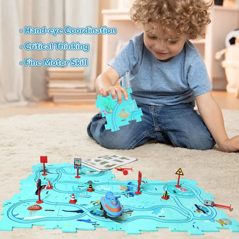 Child playing on floor with Ocean Edition Puzzle Track Car Play Set For Kids Ages 3 To 6 With Vehicles And Car Tracks.