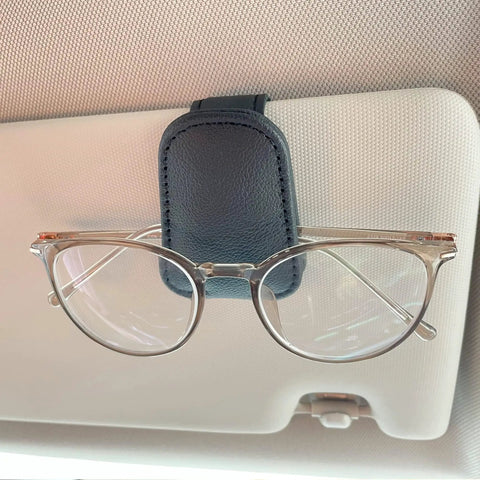 Hella Secure Magnetic Leather Car Visor Sunglasses Holder Stays Put With No Sweat Holds Eyeglasses Firmly And Keeps Tickets Organized During Daily Rides Super Convenient, featuring clear glasses held by leather clip.