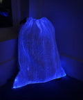 LED Fiber Optic Drawstring Backpack With 11 Lighting Modes Including 7 Colors And 4 Flash Patterns Lit Party Ready Glow For Festivals Raves And EDM Shows Plus Anti Theft Pocket And 40 By 34 Cm glowing in blue in a dark room