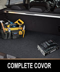 Trunk organizer with tools and a box labeled 'Complete Covor' in a car trunk