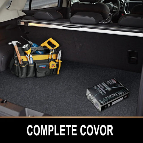 Trunk organizer with tools and a box labeled 'Complete Covor' in a car trunk