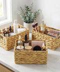 Three Pack Wicker Storage Baskets With Handles For Laundry Room And Bedroom Water Hyacinth Woven Bins Medium Size Dope Natural Color Look Durable Lightweight Organizer For Toys Clothes Books And More on countertop filled with toiletries
