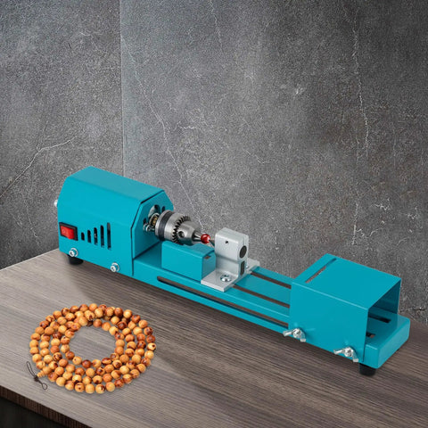 Compact Wood Lathe Machine Featuring 96 Watt Copper Motor Adjustable 4000 To 9000 Rpm Speed Aluminum Build And Dead Simple Controls on a table with beads.