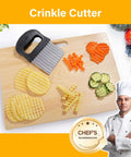 Two-pack stainless steel crinkle cutter/peeler set with black handles; sliced potatoes and cucumbers on a wooden board.