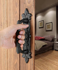 4 Pack Heavy Duty 8.9 Inch Black Cast Iron Barn Door Handles Set installed on wooden door in bedroom interior