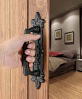 Heavy Duty 2 Pack 8.9 Inch Black Cast Iron Barn Door Handles For Garage Closet Cabinet Gates And Fences Rustic Vintage Hardware With Weather Resistant Finish Built To Last Outdoors installed on wood door with hand pulling.