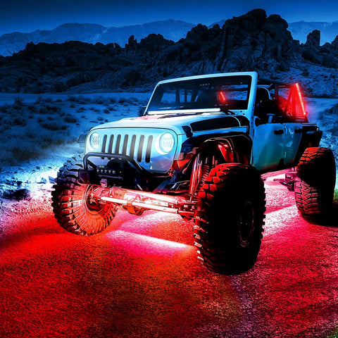 Dope Car Underglow Neon Accent Strip Lights With 252 LEDs RGB under a truck on rocky terrain, showing red and blue glow