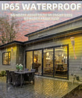 Upgraded Flickering Flame Solar Powered Torches lighting up a patio during rain, showcasing IP65 waterproof feature