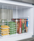 Heavy Duty Adjustable Freezer Dividers For Upright Fridge, white wire partition with frozen foods organized.