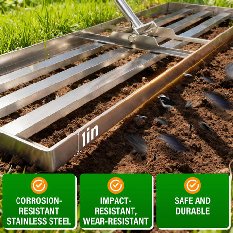 Close-up of Heavy Duty 36x12 Inch Lawn Leveling Rake With Stainless Steel Build in soil, highlighting corrosion-resistant features