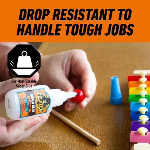 Person using Ultimate Clear Super Glue 15 Grams Heavy Duty Fast Set Bond For Quick Fixes And Home Repairs on wooden toy