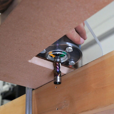 Dead Nuts Perfect Single Grip Router Base Plate For Milwaukee M18 Fuel Compact Router 2723 20 mounted above a wooden work surface.
