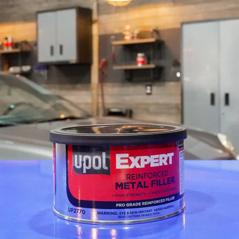 Front view of 237ml Expert Reinforced Metal Filler With Aluminum Reinforcement, auto repair filler in a workshop setting.