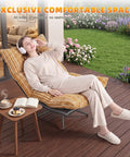 Woman relaxing on Big Comfy Rocking Swivel Chair With 360 Degree Spin And Adjustable Backrest in yellow stripe on patio