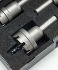 Angled top-front view of EZARC carbide hole saw kit, 3-piece set with pilot drill bits, stored in foam case