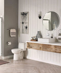 Modern bathroom with Times Square Single Handle Monoblock Faucet In Polished Chrome on vanity next to white sink.