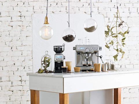 Dual Boiler Espresso Machine in Brushed Stainless Steel Featuring 58mm Commercial Portafilter and Precision Temp Control for Killer Shots and Legit Barista Quality Coffee at Home on a kitchen counter with coffee accessories.